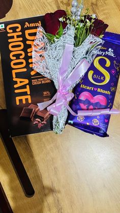 a chocolate bar and flowers on a table