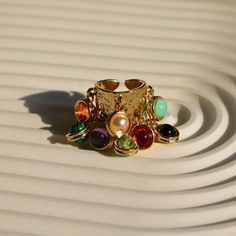 💎 Make a statement with our Gold Chunky Boho Ring! This thick band ring, with its multicolor gemstones and irregular design, is the perfect blend of baroque style and boho chic. An adjustable band ensures a comfy fit, making it an ideal gift for lovers of maximalist, boho and Y2K rings. Elevate your Fall look with this trendy, aesthetic ring! 🌟✨  #GoldChunkyRing #BaroqueRing #ChunkyBohoRing #MulticolorRing Refunds/Returns: You have 14 days after receiving the product to get all of your money b Multicolor Metal Rings For Gifts, Multicolor Bohemian Open Ring Jewelry, Bohemian Multicolor Open Ring Jewelry, Unique Adjustable Multi-stone Crystal Ring, Adjustable Multi-stone Crystal Ring In Unique Style, Handmade Multicolor Metal Rings, Multicolor Metal Bohemian Rings, Bohemian Multicolor Metal Rings, Handmade Multicolor Open Ring Jewelry