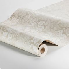 a roll of white wall paper on top of a table