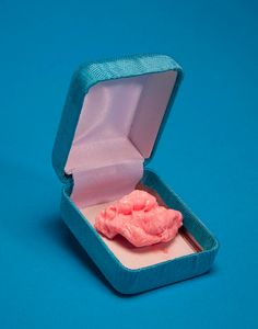 a small pink object in a blue box