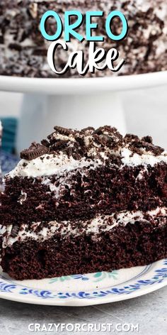 a slice of oreo cake on a plate with the rest of the cake in the background