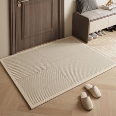 a living room with a white rug and two slippers on the floor next to it