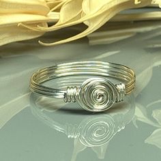 "Handmade Dainty Swirl Sterling Silver, Yellow or Rose Gold Filled Wire Wire Wrapped Ring; Custom Made to Size *This dainty swirl wire wrapped ring is handmade with an approximately 8mm in diameter silver swirl in your choice of wire. *This ring (as well as all the others in my shop) is custom made to any size from 4 to 14 including half and quarter sizes!  DIRECTIONS FOR CHECKOUT To checkout, please select the SIZE of the ring and your choice of BAND COLOR/WIRE from the drop down menus.     Ban Handmade Adjustable Swirl Ring, Wire Wrapped Ring, Wire Ring, Diy Wire Jewelry, Wire Rings, Wire Wrapped Rings, Argentium Silver, Wrap Rings, Ring Sterling Silver