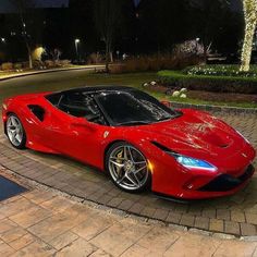 a red sports car is parked on the street