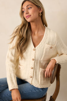 Stay ahead of the fashion game with our Quiet Days Ivory Cable Knit Cardigan. This stylish and versatile sweater is the perfect addition to your wardrobe, allowing you to effortlessly elevate any outfit. With its soft and cozy fabric, you'll feel confident and comfortable all day long. Don't miss out on this must-have piece! This ivory cardigan features a v-neckline, a functional button front with gold buttons, a cable knit grid design, functional pockets, braided knit hems, and long sleeves. Elegant Fall Sweater With Soft Texture, Elegant Cream Sweater For Loungewear, Elegant Cream Sweater For Fall, Cream Knit V-neck Outerwear, Chic Cream Sweater With Soft Knit, Chic Fall Sweater With Soft Texture, Chic Cream Soft Knit Sweater, Chic Soft Texture Sweater For Fall, Chic Soft Sweater For Fall