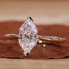 a diamond ring sitting on top of a wooden table