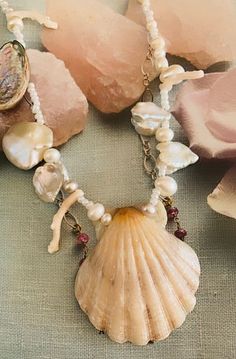 a shell and pearls necklace on a table