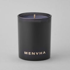 a black candle with the word menvyha written on it