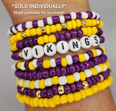 a stack of bracelets with the word viking spelled on them in white, yellow and purple beads