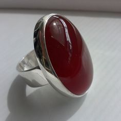 "Carnelian Silver Ring This is a classic ring with a beautiful red Carnelian 30 x 22 mm, settled on Sterling Silver band width 8 mm. Carnelian, in shades of red combines the energy of the pure red ray, and the exuberance and joy of the orange. It is the color of strength and vitality, both physical and spiritual. This ring match with the pendant that you can see in the following link: http://etsy.me/1WOrkQM If you want order the ring and the pendant, ask me for an additional 10 % OFF. *This jewe Red Carnelian Ring With Polished Finish, Red Carnelian Rings With Polished Finish, Red Polished Carnelian Rings, Red Oval Cabochon Ring, Red Carnelian Oval Cabochon Ruby Ring, Oval Red Carnelian Jewelry, Red Oval Cabochon Ring With Polished Finish, Formal Red Carnelian Ring, Red Carnelian Cabochon Ruby Ring