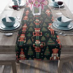 a christmas table runner with nutcrackers and trees on it, along with place settings