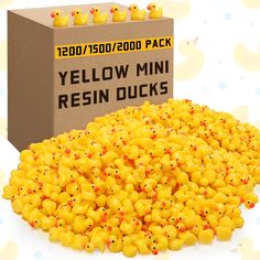 a box filled with yellow mini resin ducks next to a pile of rubber ducks on a white background