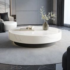 a modern living room with white furniture and black accents on the walls, along with marble flooring