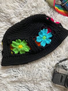 Look shagedelic in this groovy rainbow flower bucket hat🌈✨ Made with bright neon colored and black acrylic yarn. This hat fits average sized adult heads.MEASUREMENTS 23 inches around7 inches from crown to brim3 inch wide flower band1.25 inch wide brim6.5 inches across top of hatHand/gentle wash and air/tumble dry for best results.Do not bleach or iron.Message me about custom sizing and/or colors. Feel free to let me know your questions and concerns🌸 Black Fun Bucket Hat For Summer, Fun Black Bucket Hat For Summer, Fun Black Summer Bucket Hat, One Size Black Crochet Hat For Spring, Trendy Black Crochet Hat, Trendy Multicolor Acrylic Hats, Fun Black Bucket Hat For Spring, Trendy Black Crochet Hat For Spring, Trendy Black Handmade Crochet Hat