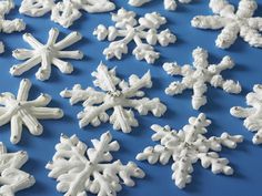 white snowflakes on a blue background are arranged in the shape of snow flakes