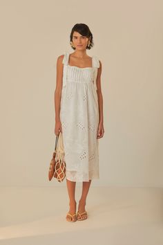 Embrace the soft allure of the Off-White Midi Dress from FARM Rio. This enchanting piece features feminine eyelet embroidery that dances across a delicate off-white fabric. With its square neckline and charming ruffle-trimmed straps, this dress exudes a romantic touch. The relaxed silhouette falls gracefully to mid-calf, and the lovely bow detailing at the back ensures a sweet exit. Perfect for sunny days or moonlit strolls, it’s a dress that whispers of daydreams and gentle elegance. Composition 65% COTTON 30% LYOCELL 5% POLYESTERCare Instructions HAND WASH SEPARATELY, DO NOT BLEACH. DO NOT TUMBLE DRY, LINE DRYING, IRON AT LOW HEAT, DO NOT DRY CLEANSize and Fit Inches XXS XS S M L XL Bust 30 32 33 3/4 35 3/4 39 42 1/4 Waist N/A N/A N/A N/A N/A N/A Length 38 1/4 39 39 2/4 40 1/4 41 41 2/4 Summer Square Neck Dress With Broderie Anglaise, Summer Wedding Dress With Eyelet Details, White Broderie Anglaise Dress With Square Neck, White Square Neck Dress With Broderie Anglaise, Square Neck Broderie Anglaise Daywear Dress, Broderie Anglaise Square Neck Dress For Garden Party, Minimal Wedding Dress, Eyelet Embroidery, Minimal Wedding