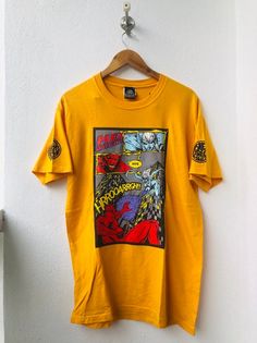 PLEASE ASK ANY QUESTION BEFORE BUYING!!! THIS IS USED CLOTHING!!! PLEASE DONT EXPECTED IT TO BE LIKE NEW OR IN PRISTINE CONDITION!!!PLEASE REFER TO THE ACTUAL/MANUAL SIZE TAKEN!!!Size on tag : MCondition : 8/10Made : USA assembly HondurasColor : Yellow / Brand Logo / ArtMeasurement :armpit to armpit= 20"inchesLenght from top of the shoulder to bottom= 30"InchesIn a good vintage condition Vintage but still good and niceNo tears No Stains and GoodSHIPPING (Your Choice Please read)1. The shipping c Unisex Character Print T-shirt For Streetwear, Graffiti Print T-shirt For Skateboarding, Yellow Hip Hop Top With Graphic Print, Yellow Graphic Print Hip Hop Top, Yellow Graphic Print Band Merch Top, Pop Culture T-shirt With Front Print For Streetwear, Unisex Pop Culture T-shirt For Streetwear, Pop Culture Front Print T-shirt For Streetwear, Hip Hop Style Yellow T-shirt With Screen Print