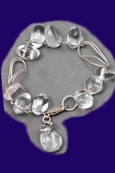 a silver bracelet with clear glass beads