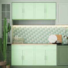 a kitchen with green cabinets and a cactus