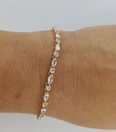 This is a really stunning tennis style bracelet featuring 6 x 3 mm marquise shaped and 3 mm round lab created white sapphire stones. the bracelet is made from one of the best lab created sapphire materials that is grown in switzerland. the bracelet has an incredible amount of sparkle. lab created sapphires are chemically and structurally the same as earth mined stones, only they are grown in a lab. there are 34 stones totally about 6 carats.  there is about 6 grams of sterling silver in the brac Fine Jewelry Marquise Tennis Bracelet As Gift, Marquise Cut Cubic Zirconia Tennis Bracelet As Gift, Sapphire Stones, Tennis Style, Gold Plated Bracelets, Sapphire Stone, White Sapphire, Chain Link Bracelet, Matching Earrings