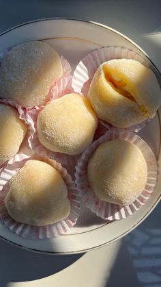 several small pastries are placed in a bowl on a table top, ready to be eaten