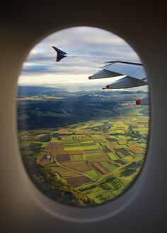 an airplane window looking out at the countryside