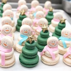 there are many small snowmen on top of macaroons