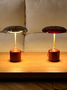 two lamps sitting on top of a wooden table