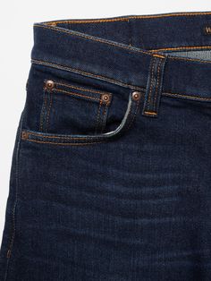 Tight-fit jeans in a deep, dark wash, featuring sharp yet subtle wear marks. Crafted from deeply saturated denim, these jeans exhibit a rustic, three-dimensional texture. The wash enriches the indigo's depth, while the wear subtly adds contrast and a worn-in appearance, giving these jeans a clean yet subdued look. Classic Medium Wash Jeans With Hip Pockets, Classic Dark Wash Pants With Hip Pockets, Classic Dark Wash Jeans With Hip Pockets, Indigo Mid-rise Jeans With Five Pockets, Dark Wash Straight Selvedge Jeans, Straight Selvedge Jeans In Dark Wash, Straight Selvedge Dark Wash Jeans, Dark Wash Selvedge Tapered Leg Jeans, Dark Wash Tapered Jeans With Hip Pockets