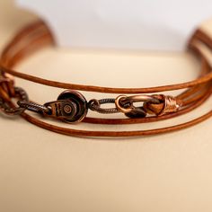 Approx. 14" Handmade in Laurel, Mississippi Beautifully colored natural brown leather with Novi's signature clasp allowing it to snap together with other NoVi bracelets for an original look. Wraps around the wrist twice, or can be worn as a choker. For a looser fit, add an extender! Vintage Adjustable Jewelry With Leather Strap, Adjustable Hand Wrapped Leather Wrap Bracelet, Adjustable Brown Bracelet, Unique Adjustable Bracelet With Leather Strap, Brown Leather Strap Bracelet, Vintage Brown Wrap Bracelet, Handmade Adjustable Leather Wrap Bracelet, Adjustable Leather Strap Bracelet, Adjustable Brown Bracelets For Everyday Use