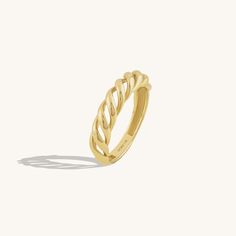 a gold ring with braiding on it