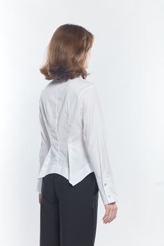 Our timeless crisp White Pima Cotton shirts are check the boxes of form and function. This season the Beam Shirt is reinvented as a bit of a shirt jacket. A shaped body which has a scalloped bottom and back with some asymmetric detail on each side. Destined to become a MATTHILDUR classic. Fitted Collared Timeless Top, Timeless Tailored Tops For Office, Fitted Timeless Collared Top, Timeless Fitted Collared Top, Timeless Office Tops With Concealed Placket, Timeless Office Top With Concealed Placket, Tailored Tops With Fold Down Collar For Work, Fitted Business Casual Tops With Shirttail Hem, Timeless Fitted Top For Office Wear