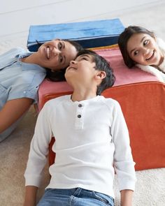 two women and a boy laying on the floor