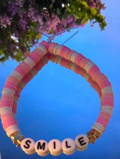 This is a Clay beaded Bracelet. It quotes,"Smile". The colors include pinks, and white. This is made from stretchy string! Preppy Clay Beads, Clay Beaded Bracelet, It Quotes, Quotes Smile, Bracelet Inspo, Clay Bracelet, Bead Ideas, Beads Bracelets, Clay Bead