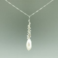 One of a kindHandmade in Seattle Unique long oval baroque pearl with smaller white and pale grey pearls on polished silver chain Materials: solid sterling silver fresh water pearls Measurements: Adjustable necklace chain: 17" - 19" Pendant area: 2 5/8" long x 3/8" wide Comfortable - Adjustable length fits varying necklines and light weight makes it easy to wear Timeless - pearls never go out of style High Quality - all chain connections are welded and pearls/gems are tightly wire wrapped, custom Silver Pearl Drop Necklaces, White Long Drop Necklace With Pearl, White Pearl Necklace With Silver Chain, Silver Drop Necklace With Pearl Chain, Silver Drop Pearl Necklace With Pendant, Silver Pearl Necklace With Drop Shape, Silver Long Drop Necklace With Pearl, Silver Baroque Pearl Necklace For Anniversary, Sterling Silver Lariat Pearl Necklace