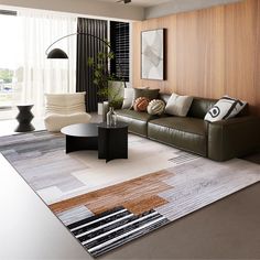 a living room with couches, tables and rugs on the floor in front of large windows