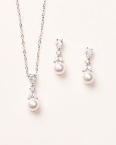 two pieces of jewelry set on a white background, including a necklace and earring