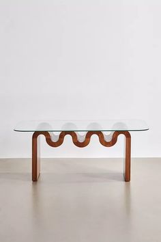 a glass and wood table with wavy legs