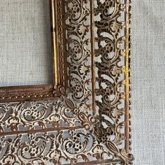 an ornate gold framed mirror sitting on top of a white wall