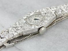 "A gorgeous vintage watch with a luxurious old Hollywood style, this piece was crafted by the Glycine Watch Company in the mid-1900's! Crafted of stunning platinum, encrusted with single cut diamonds. The glittering gems turn this timepiece into a piece of fine ladies jewelry. This beautiful ladies wrist watch is in excellent condition and, like all of our watches, has been restored and cleaned by a master watch craftsman. Manufacturer: Glycine Jewel Count: 17 Materials: Platinum, Glass Gem: 88 Glycine Watch, Ladies Wrist Watch, Art Deco Watch, Antique Costume Jewelry, Old Hollywood Style, Hollywood Style, Market Square, Real Jewelry, Watch Vintage