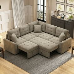 a living room with a large sectional couch and matching footstools on the floor