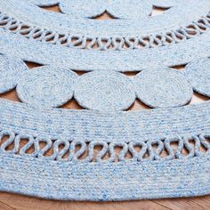 a close up of a rug on the floor with circles and chains around it,