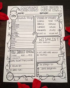 the santa's helper activity sheet with red rose petals around it on a wooden table