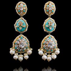 Pull of an ethnic look with a dash of modernity in these stunning earrings! Beautiful, stand-out statement earrings in a mesmerizing design decked out in CZ stones and accented with feroza or pink stones and white pearls. Approximate earrings length is 4". Gold-plated on high-quality brass as base metal. Made by order. Kindly allow 4-6 weeks for the delivery of this item. For custom or urgent requests, please contact support@alacouture.com. *Please Note: We use faux stones and beads in all of ou Luxury Multicolor Temple Jewelry Bridal Earrings, Luxury Multicolor Temple Jewelry Earrings, Luxury Multicolor Temple Bridal Earrings, Elegant Turquoise Kundan Earrings, Turquoise Kundan Earrings For Wedding, Elegant Turquoise Meenakari Earrings, Elegant Turquoise Earrings For Festivals, Elegant Turquoise Earrings For Festive Occasions, Elegant Turquoise Earrings For Festive Season