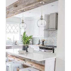 a kitchen island with stools in front of it