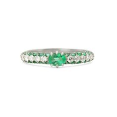 an emerald and diamond ring on a white background