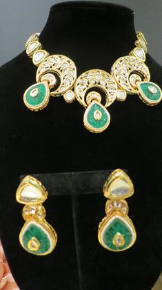 This beautiful choker is a modern twist to traditional jewelry and comes in a gold finish with green stones to match any outfit as desired. The choker is made of high quality stones and is a statement piece that can be dressed accordingly. The set comes with matching earrings for a complete look. Green Gold-plated Kundan Necklace For Festivals, Green Gold Plated Kundan Necklace For Festivals, Green Kundan Necklace For Formal Occasions, Formal Green Kundan Necklace, Hand Set Green Kundan Necklace, Green Hand-set Kundan Necklace, Green Elegant Kundan Necklace For Party, Elegant Green Kundan Necklace For Party, Elegant Green Emerald Necklace With Stone Work