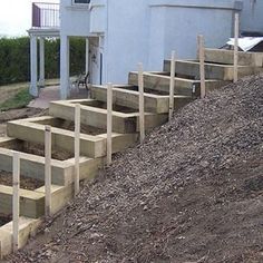 wooden steps are lined up on the side of a house