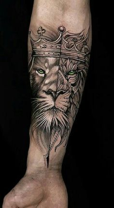 a lion with a crown on his head and green eyes is shown in this forearm tattoo