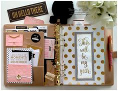 an open planner with gold foil and pink accents